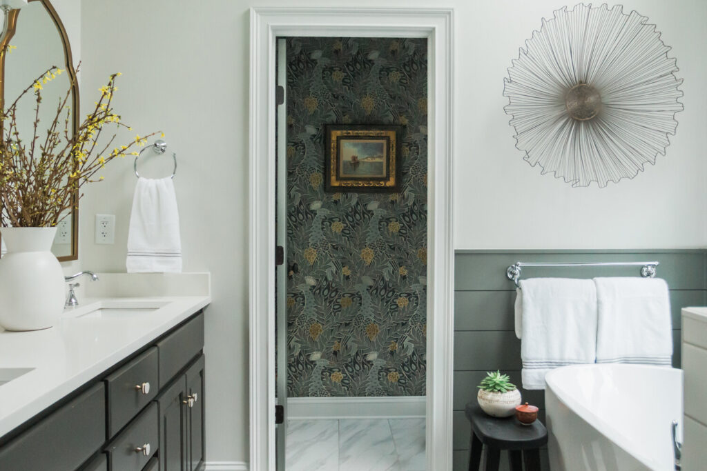 Muted blue and gold peacock wallpaper in the bathroom of the Black Oak Project. Just the right amount of flair to pull off modern southern style.