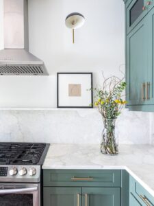 White marble continuous backsplash, where countertops continue up the wall as a backsplash to help elongate the room. 