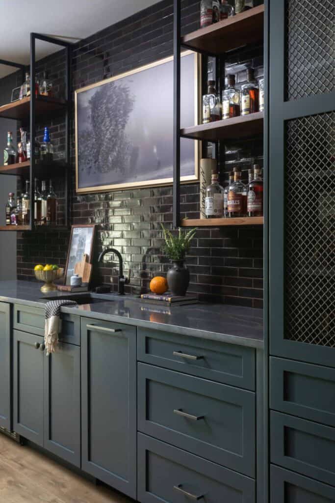 Built-in bar with navy cabinets, custom whiskey cabinet, and liquor shelves.