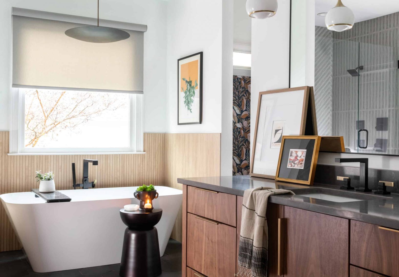 Mid-century minimalist bathroom with black and wood accents and white basin bathtub.